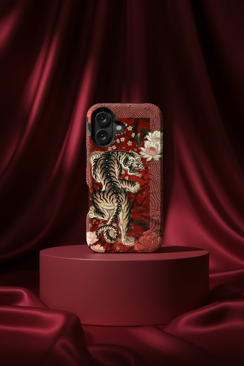 Phone case with tiger design on a red platform against a red curtain background